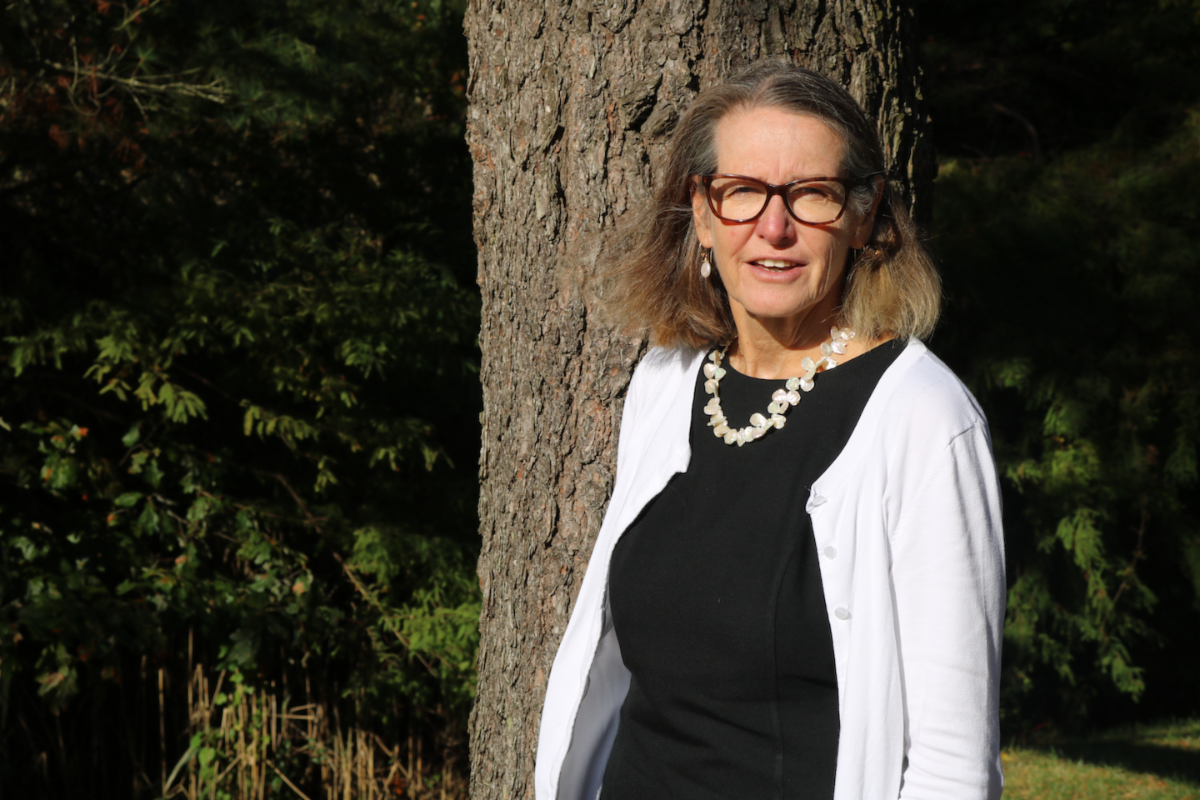 Executive Director of the Hughes Center, Nancy Nunn, pictured in front of a tree.